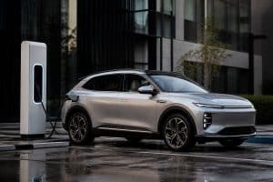 SUV électrique moderne branché à une borne sur une aire de recharge